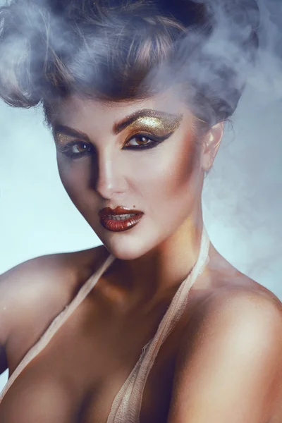 Portret van mooie brunette met make-up en rook achtergrond — Stockfoto