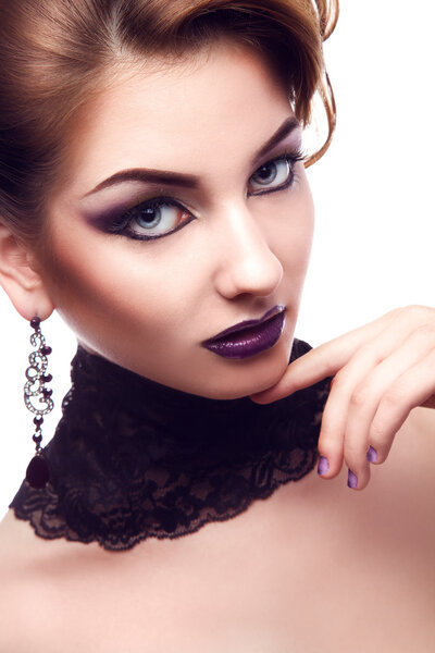 Vertical portrait of serious woman with violet make up