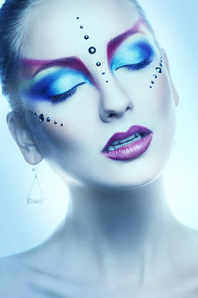 Vertical portrait of cutie woman with multicolor make up in stud — Stock Photo, Image