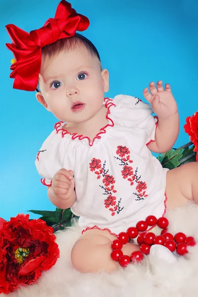 Little child with red bow, flowers and necklace — Stock Photo, Image