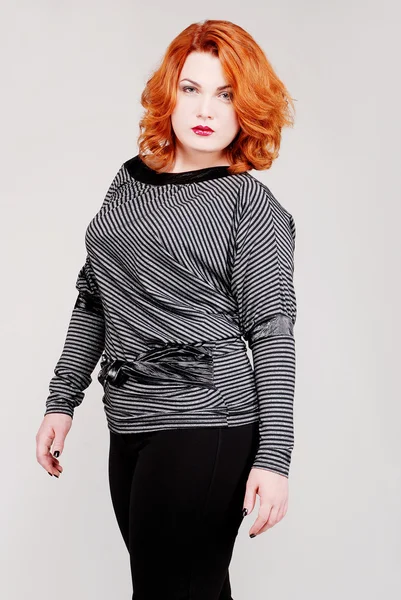 Attractive young redhead woman in stylish clothes — Stock Photo, Image