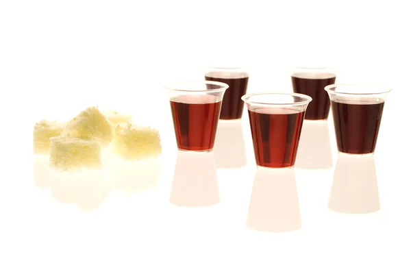 Plastic communion cups with wine and bread — Stock Photo, Image