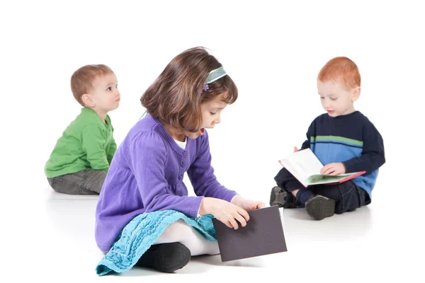 Sitting kids reading books — Stock Photo, Image