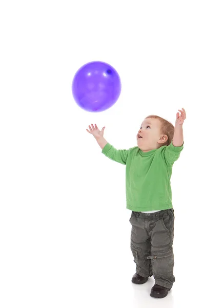 Toddler playing with purple balloon — Stock Photo, Image