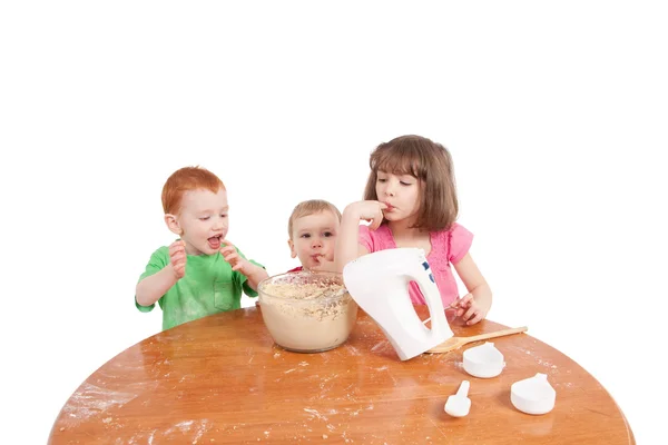 Kids tasting cake mix — Stock Photo, Image