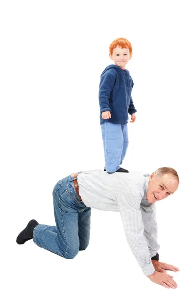 Pojke stående ridning farfar tillbaka — Stockfoto
