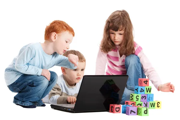 Çocuk çocuklar blokları ve bilgisayar ile okuma öğrenme — Stok fotoğraf