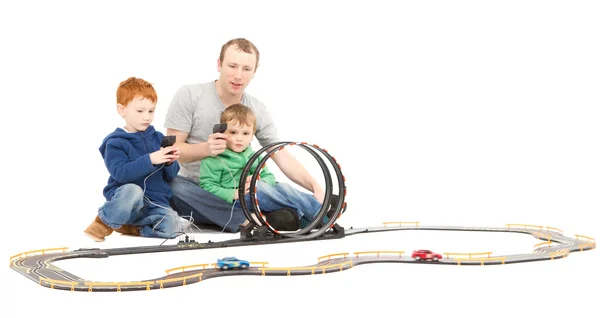 Father and children playing kids racing toy car game — Stock Photo, Image