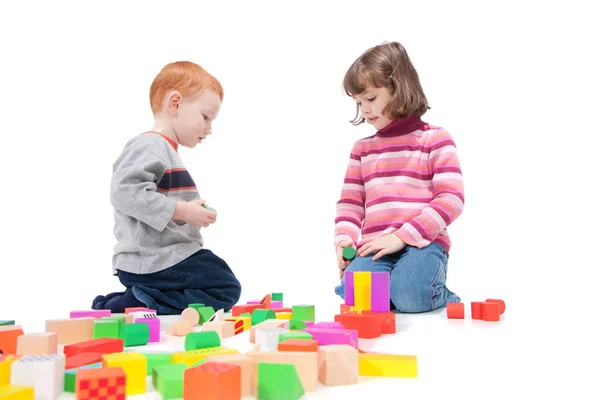 Kids playing with colorful blocks Stock Image