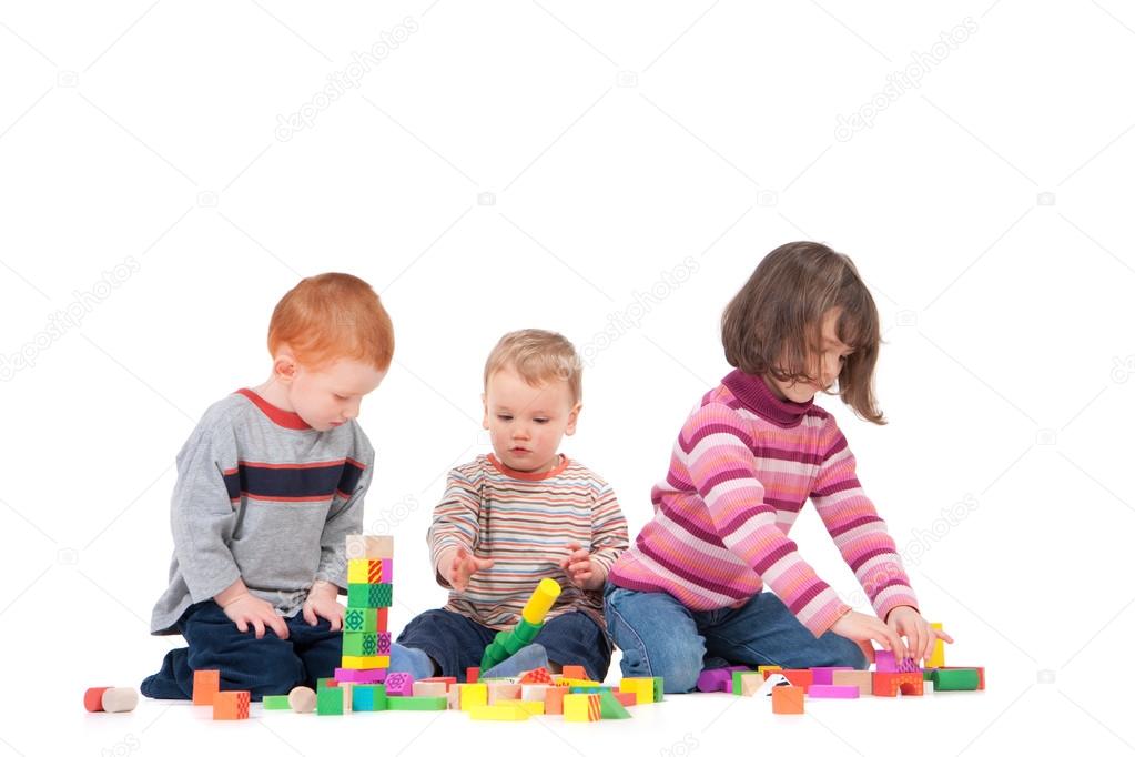 Preschoolers playing with wooden blocks Stock Photo by ©sdenness 12743314