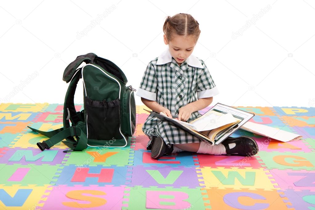 Girl student studying school reading homework book