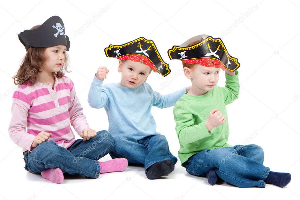 Children playing game in kids party pirate hats
