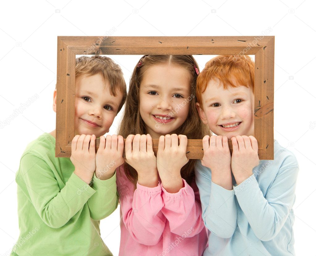 Three happy smiling kids looking through picture frame