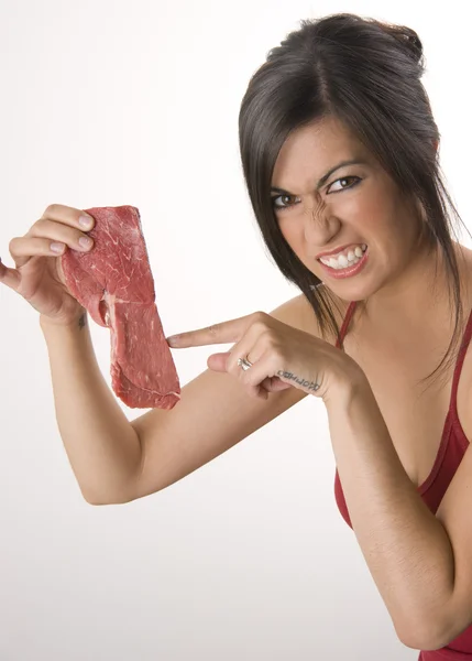 Beautiful Brunette holds raw red steak meat — Stock Photo, Image