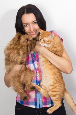 Nice woman with the cat and the dog on his hands clipart
