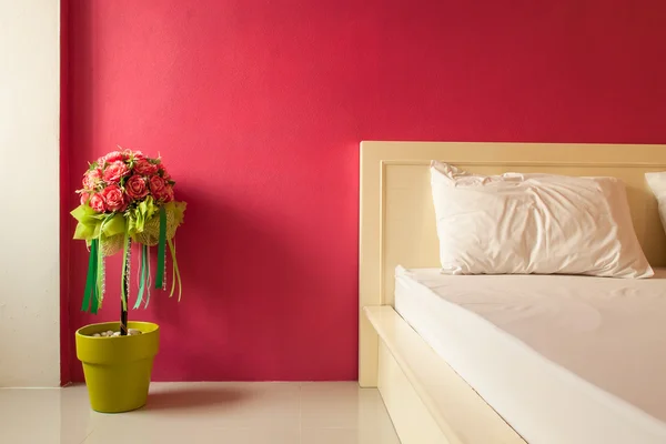 Decoration artificial flower in red bedroom — Stock Photo, Image