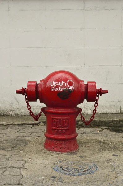 Red fire hydrant on a sidewalk. — Stock Photo, Image