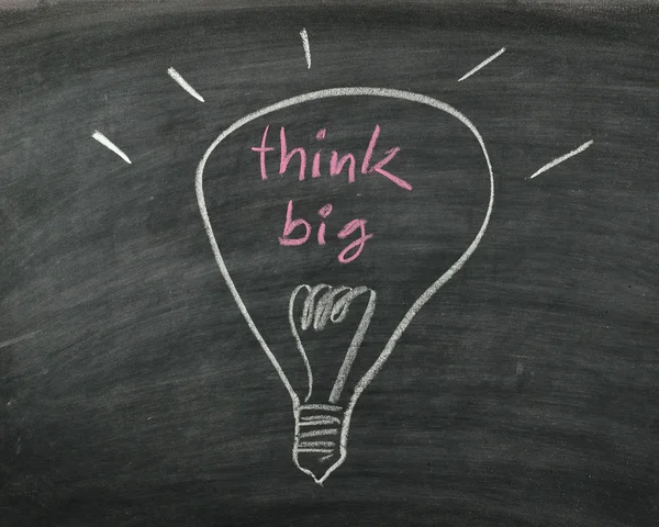 The word think big and light bulb drawn on a chalk board — Stock Photo, Image