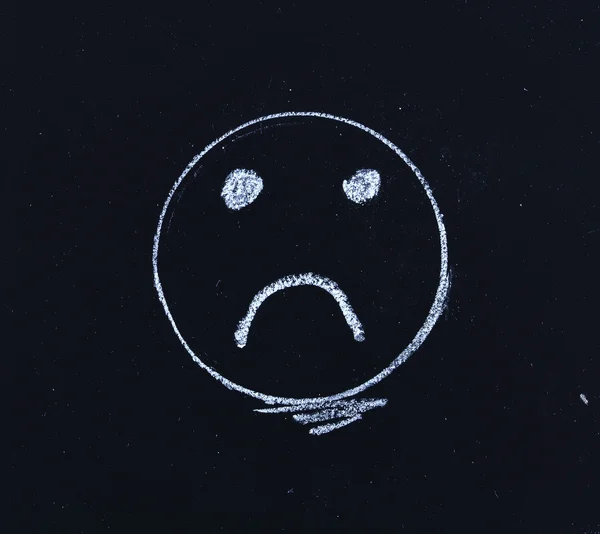 Sad smiley face on blackboard — Stock Photo, Image