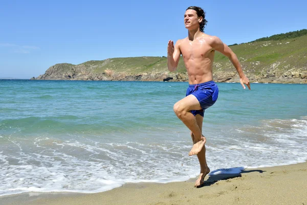 Sportsman körs på stranden — Stockfoto