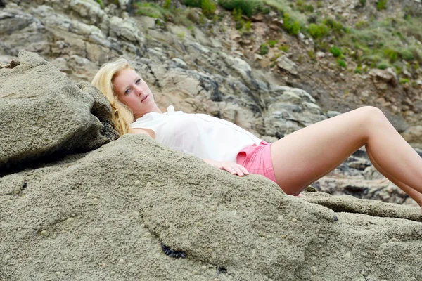 Blond girl posing on the beach Stock Image