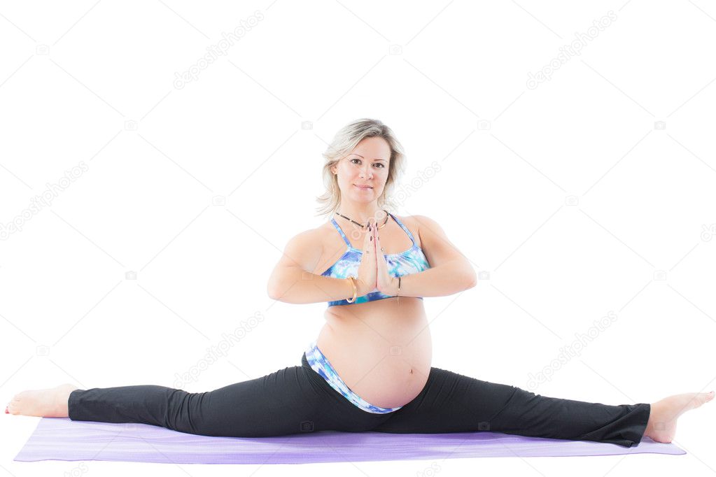 Pregnant fitness woman make stretch on yoga pose