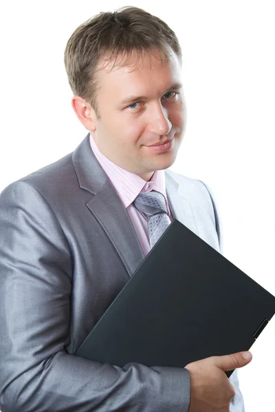 Succesvolle business man in een stijlvolle pak houdt laptop op een geïsoleerd wit — Stockfoto