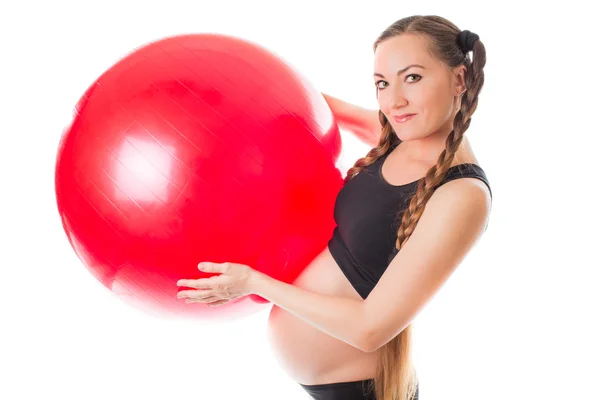 Embarazada joven haciendo ejercicio en fitball sobre fondo blanco La c — Foto de Stock