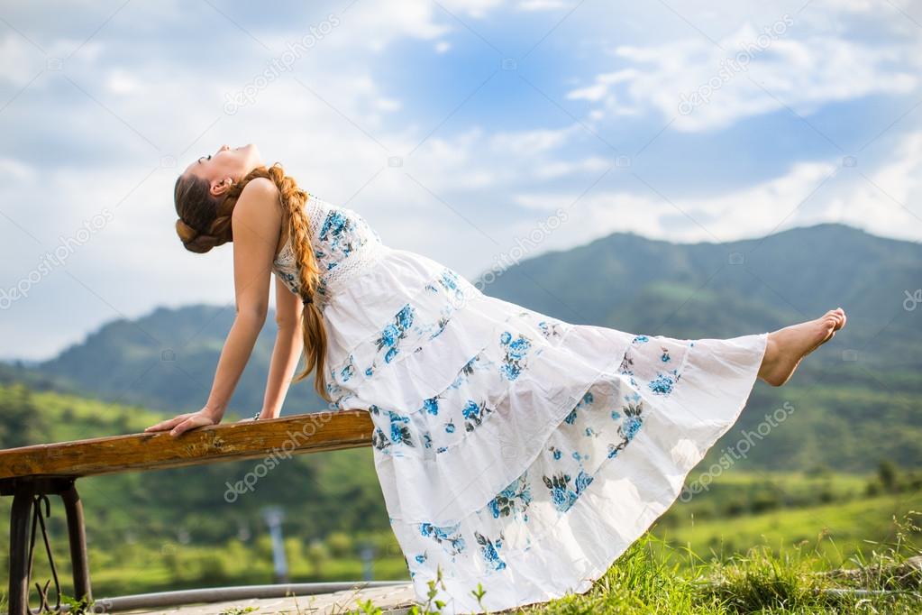 Beautiful woman with long hair meditating on nature of Almaty Young wom