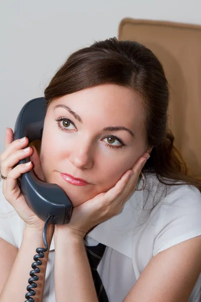 Happy office worker girl on landline phone call, listening to conversation — Stock Photo, Image