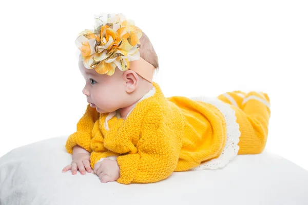 Portrait of baby girl with yellow flower on her head on white background — Stock Photo, Image