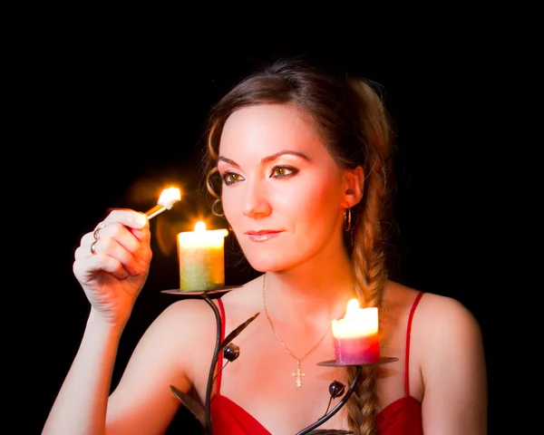 Woman wonders with a candle on Christmas night — Stock Photo, Image
