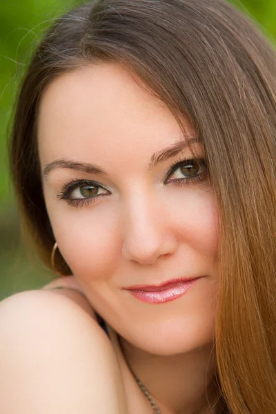 Portrait of the beautiful caucasian woman with long silky hair on nature — Stock Photo, Image