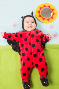 yeşil renkli çocukluk ve tatil kavramı üzerinde ladybug Kostüm giymiş, tatlı bebeğim