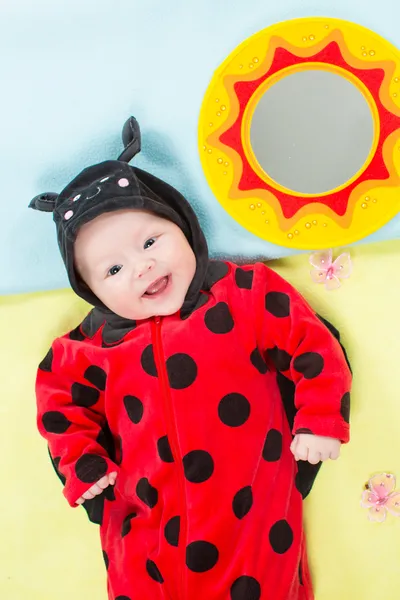 Pretty baby girl, dressed in ladybug costume on green background The concept of childhood and holiday — Stock Photo, Image