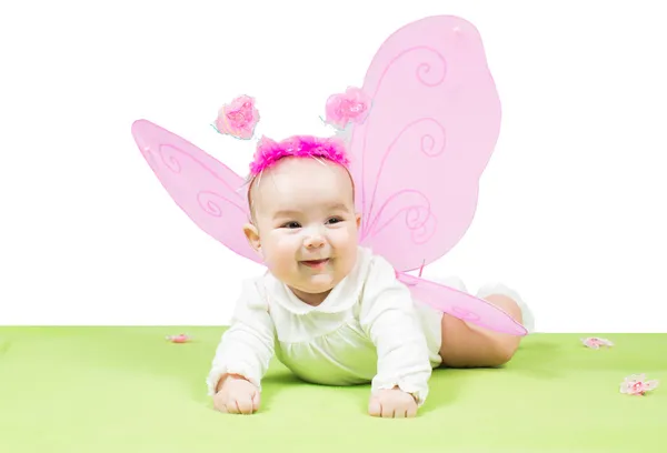Pretty child girl, dressed in butterfly costume on green background The concept of childhood and holiday Royalty Free Stock Photos