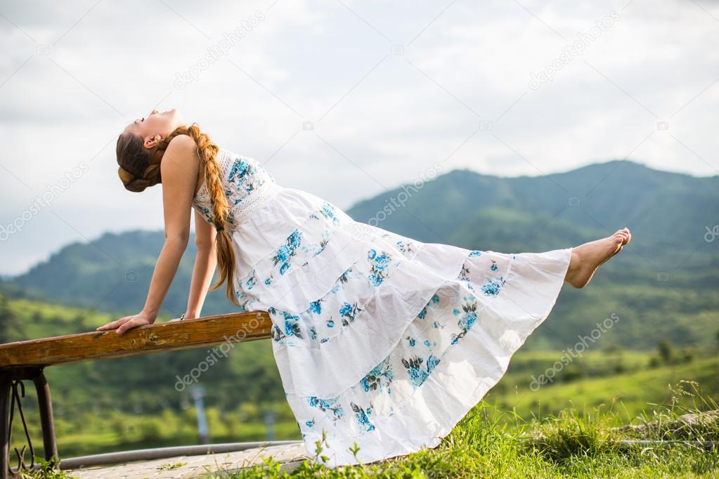 Beautiful pregnant woman meditating on nature of Almaty Young woman doing yoga