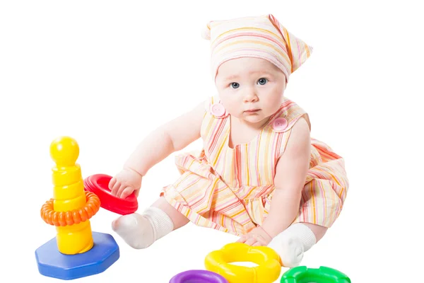 Child girl playing with toy pyramid build from rings isolated on white background — Stock Photo, Image