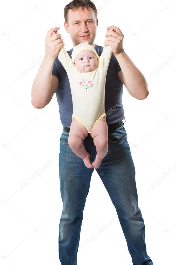 Dad does exercises dynamic gymnastics with child, holding baby in hand isolated. The concept of sports, baby yoga and healthy lifestyle