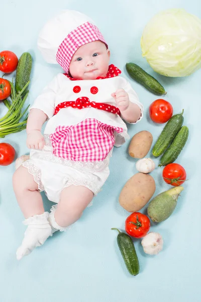 Baby girl wearing a chef hat with vegetables. Use it for a child, healthy food concept — Stock Photo, Image