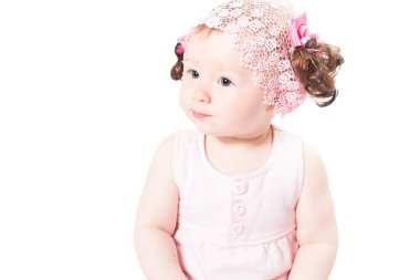 Little cute baby-girl with blue eyes in pink dress isolated on white background Use it for a child, parenting or love concept clipart