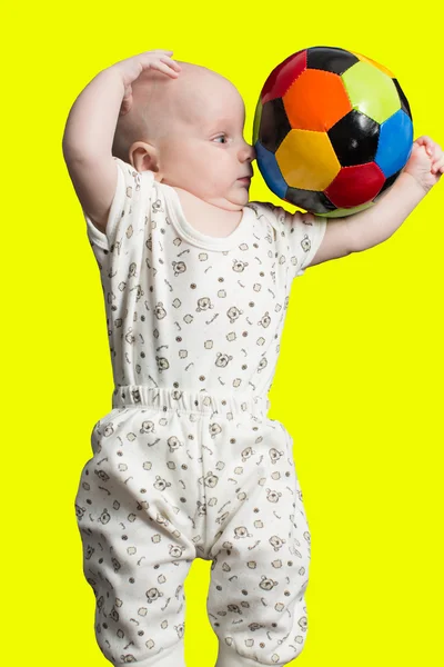 Baby boy playing with a soccer ball on color background Babies And Sport — Stock Photo, Image