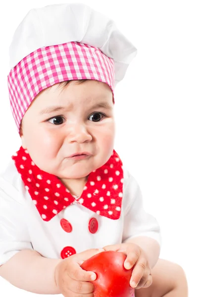 Baby girl wearing a chef hat with tomato isolated on white background.The concept of healthy food and childhood — Stock Photo, Image