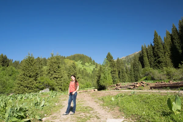 Woman with long hair on nature of green trees and blue sky, near Medeo in Almaty, Kazakhstan,Asia — Stock Photo, Image