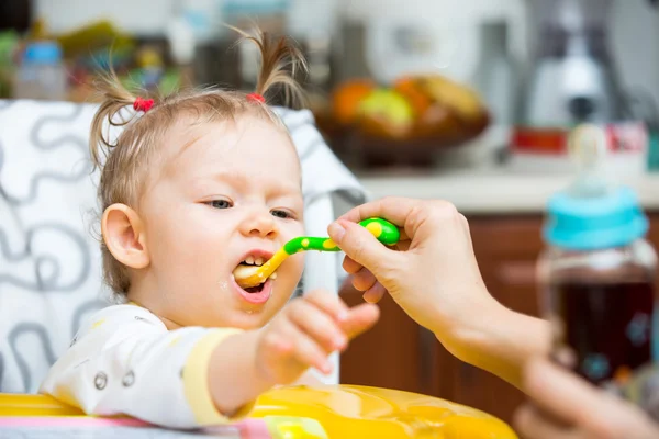 Child girl eats porridge — Stock Photo, Image