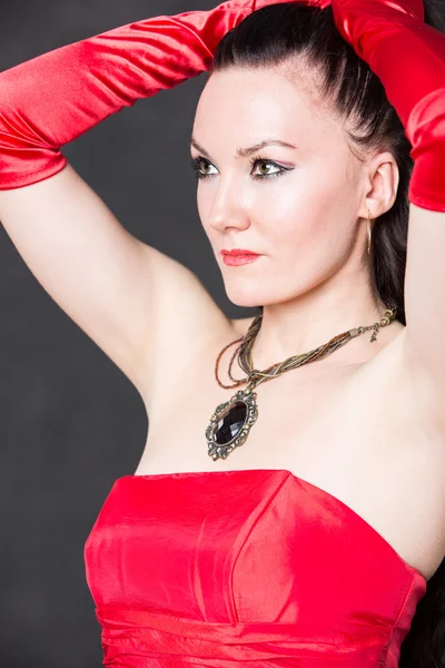 Beautiful woman in red satin dress — Stock Photo, Image