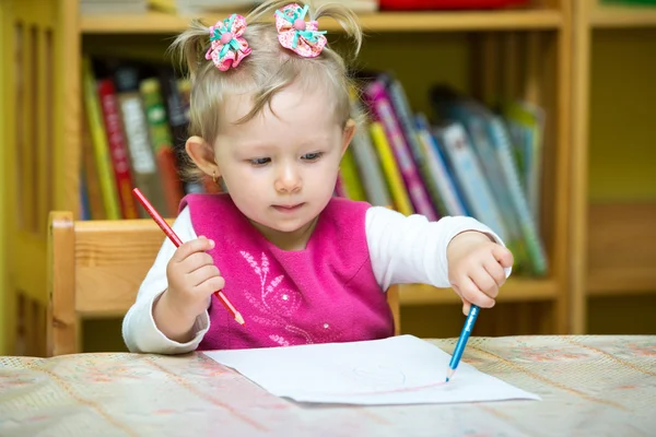 Child girl drawing with pencils in preschool Stock Picture