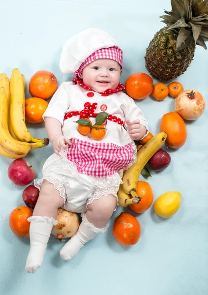 Baby girl with fruits. — Stock Photo, Image