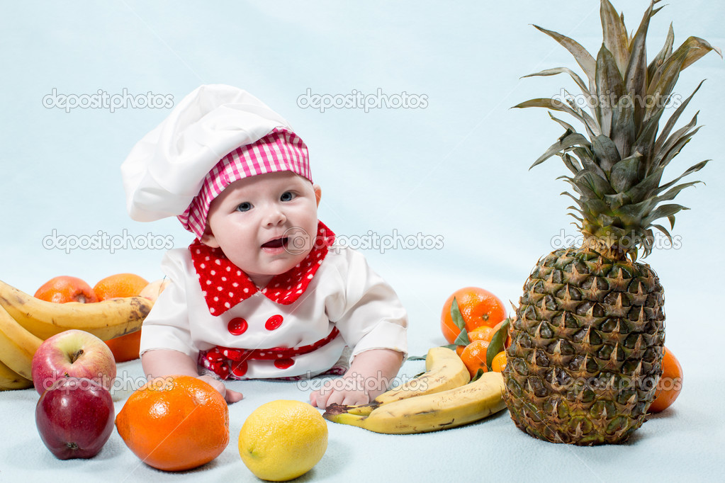 Baby girl with fruits.