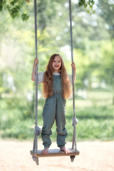 Happy Laughing Kid Girl Long Hair Enjoying Swing Ride Playground — Zdjęcie stockowe
